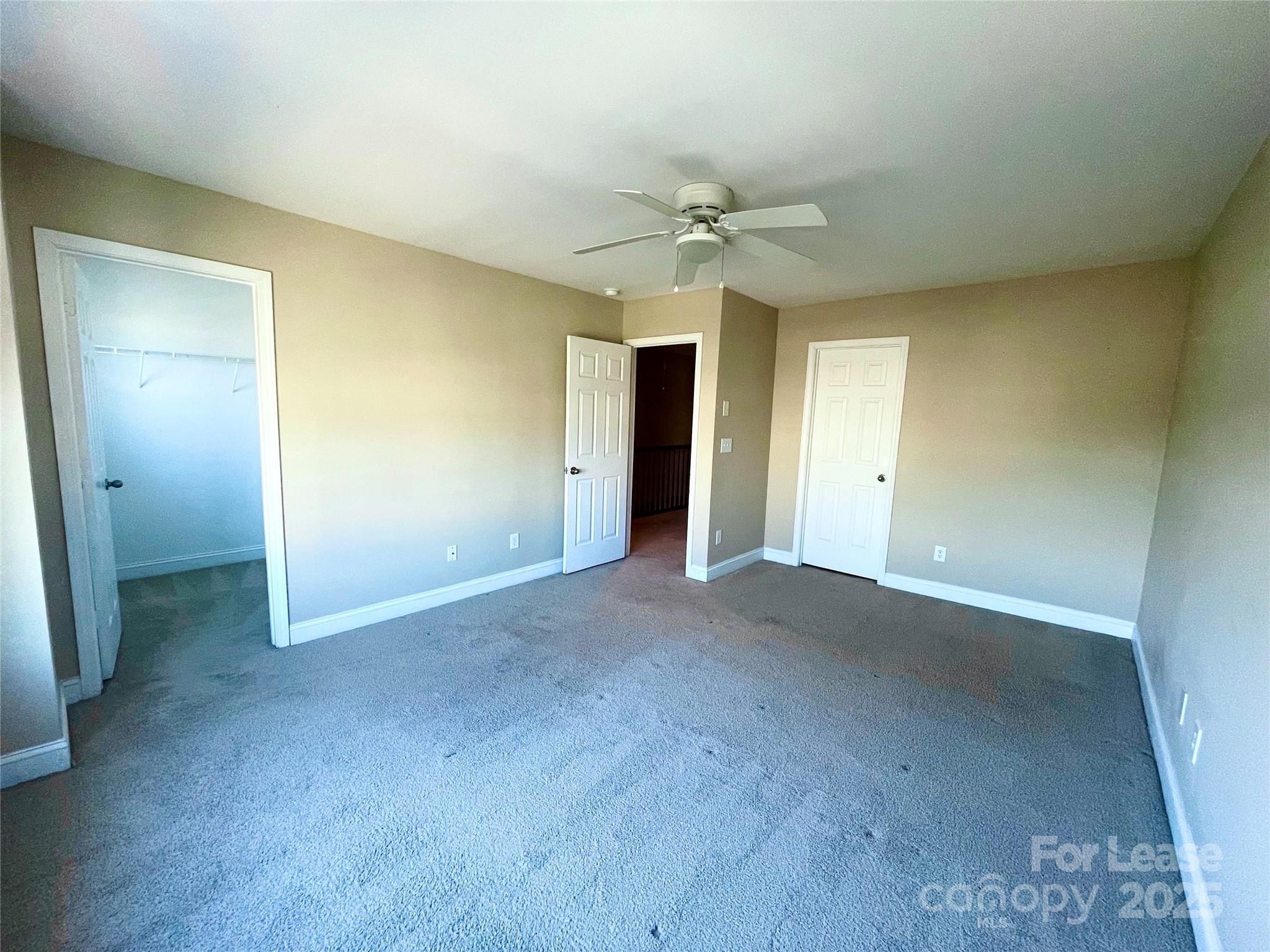 233 East Waterlynn Road, Unit A Mooresville, NC 28117 - Photo 7 of 13 a view of a big room with closet and fan