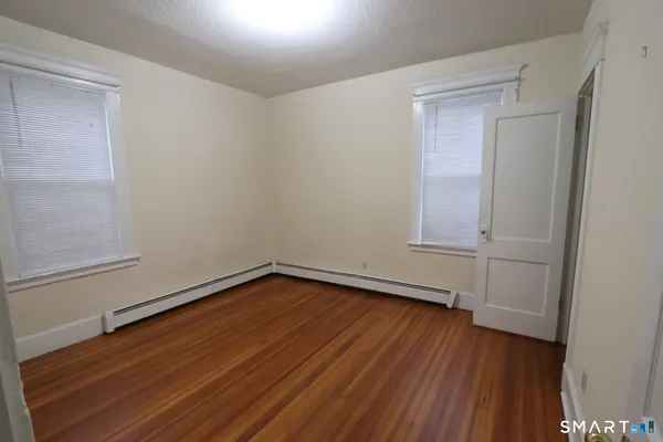 a view of a room with wooden floor and white doors