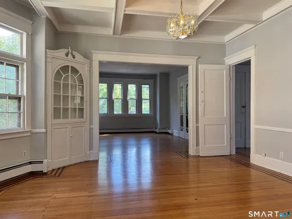 a view of an entryway with wooden floor