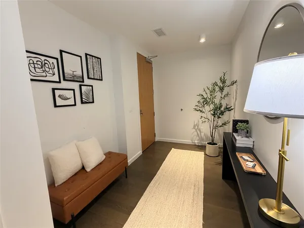 a living room with furniture and a lamp