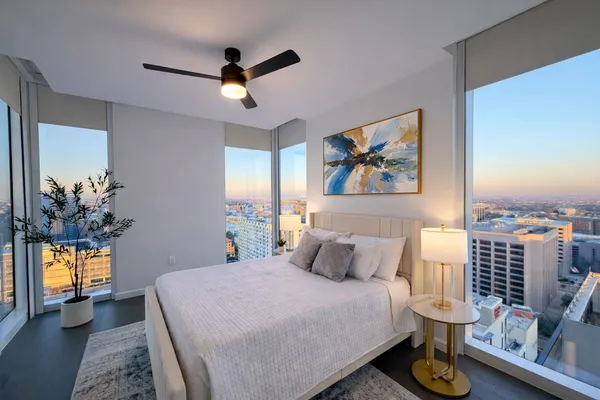 a bedroom with a bed and a chandelier