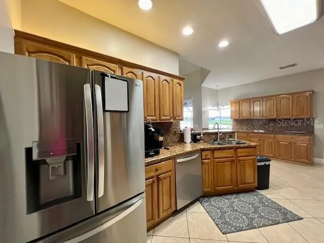 a kitchen with stainless steel appliances a stove sink microwave and cabinets