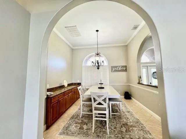 a living room with dining table and chairs