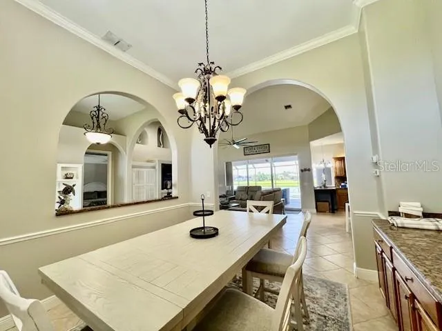 a bedroom with a bed a chandelier and window