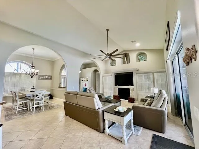 a bedroom with a bed a flat screen tv and a couch