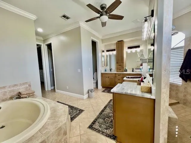 a bathroom with a toilet sink vanity granite and mirror