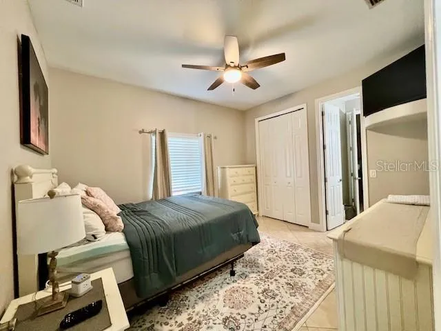 a bedroom with a bed a dresser and a window