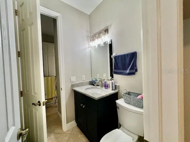 a bedroom with a large bed and ceiling fan