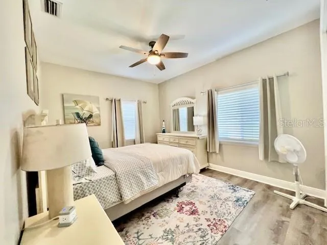 a spacious bedroom with a bed and a chandelier
