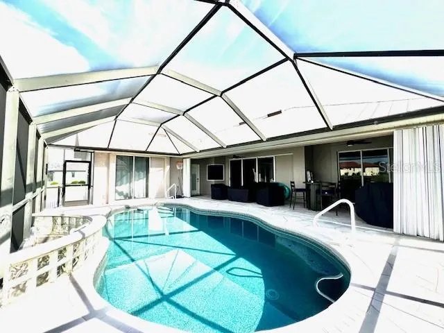 a view of a swimming pool with a couches in a patio