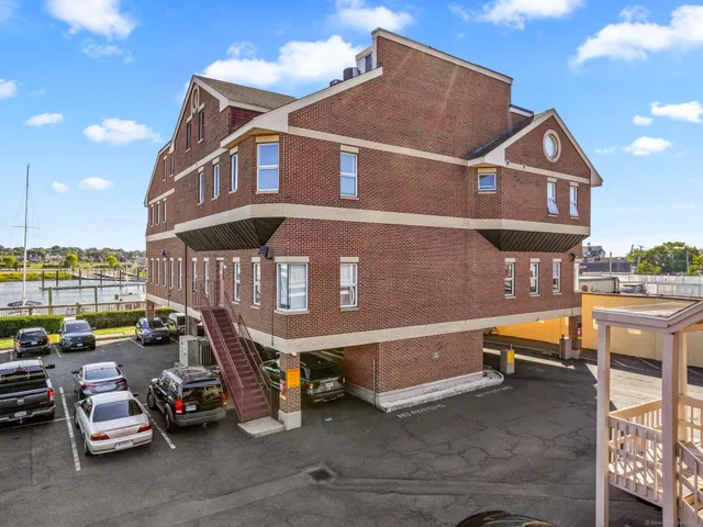 a view of a street with cars parked