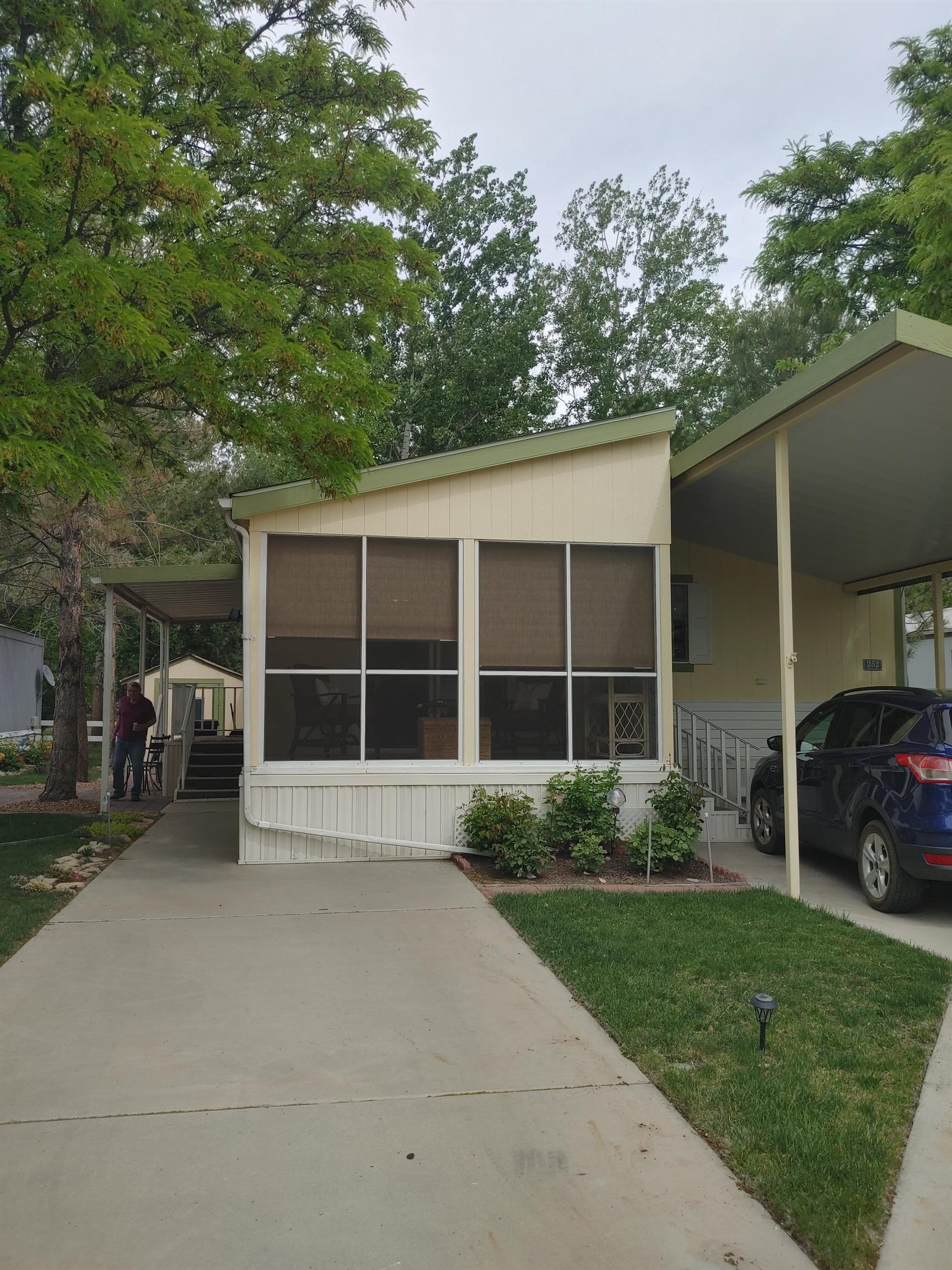 435 32 Road, Unit 252 Clifton, CO 81520 - Photo 3 of 27 a view of a house that has a bunch of plants and large trees