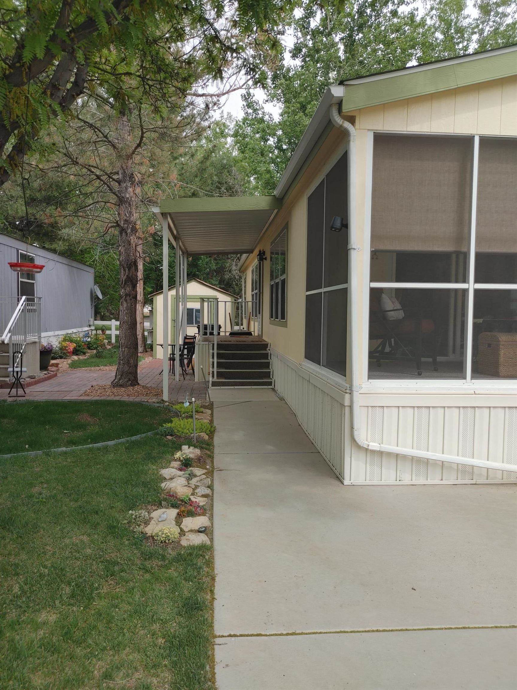 435 32 Road, Unit 252 Clifton, CO 81520 - Photo 5 of 27 a view of a house with a yard and large tree