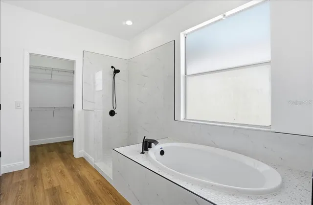 a white bath tub sitting next to a white sink
