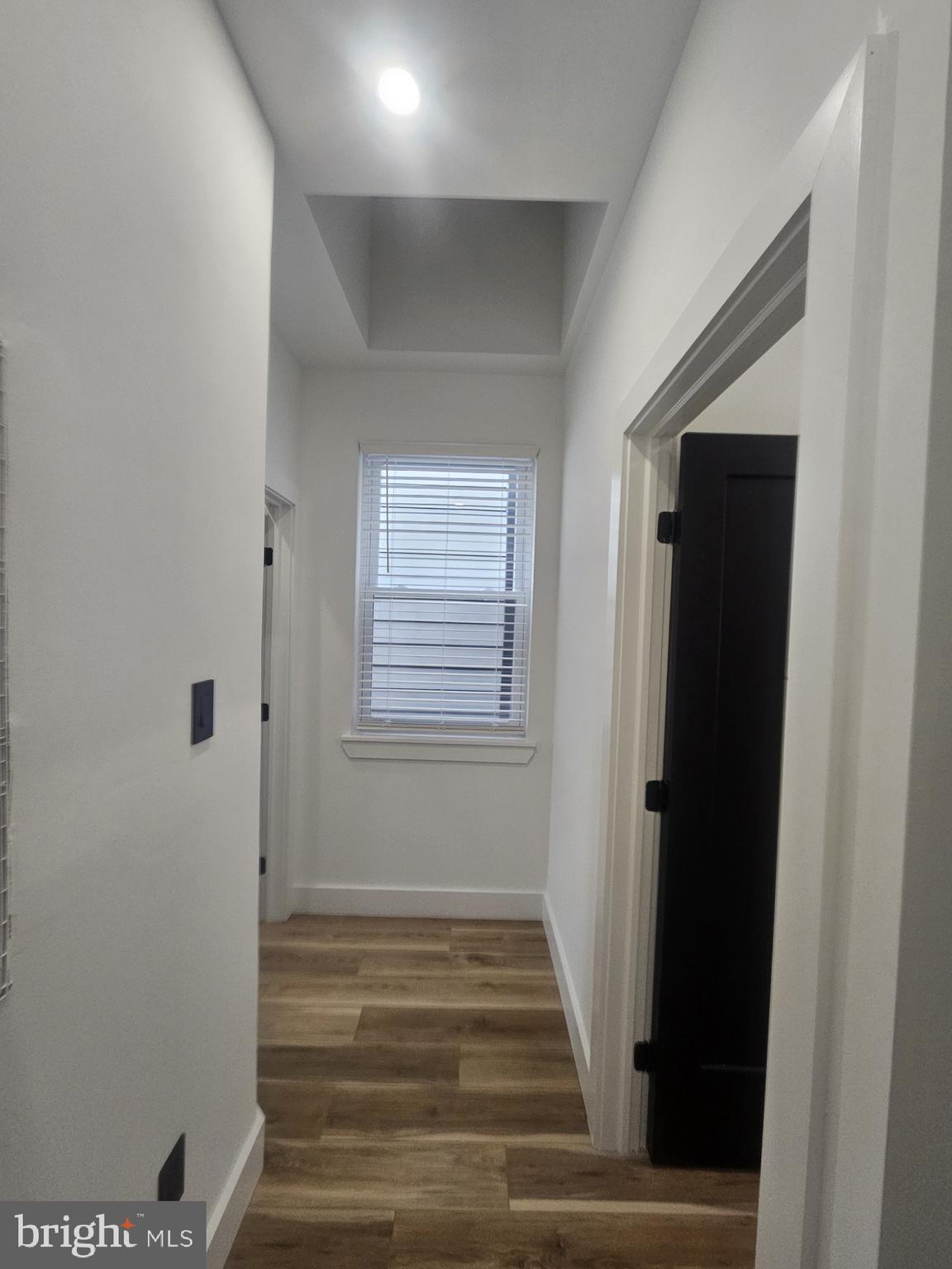 1250 North 18th Street, Unit 1 Philadelphia, PA 19121 - Photo 25 of 26 a view of a hallway with wooden floor and a window
