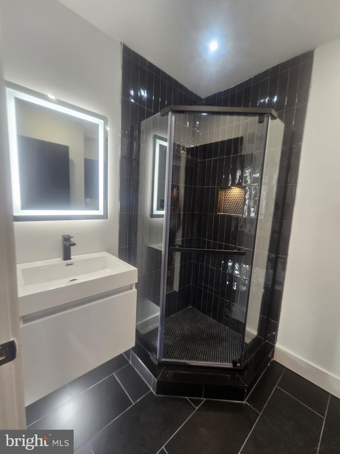 1250 North 18th Street, Unit 1 Philadelphia, PA 19121 - Photo 6 of 26 a bathroom with a shower a mirror and a sink