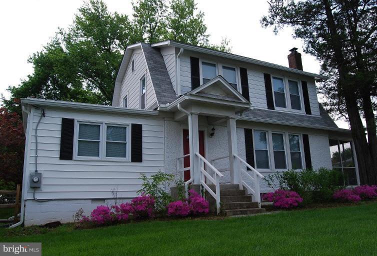 a view of a house with garden and yard
