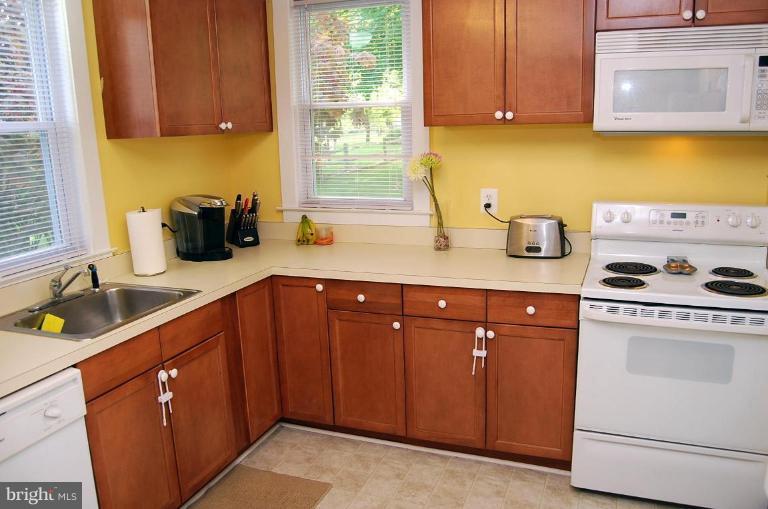26621 Ridge Road Damascus, MD 20872 - Photo 10 of 18 a kitchen with sink cabinets and window