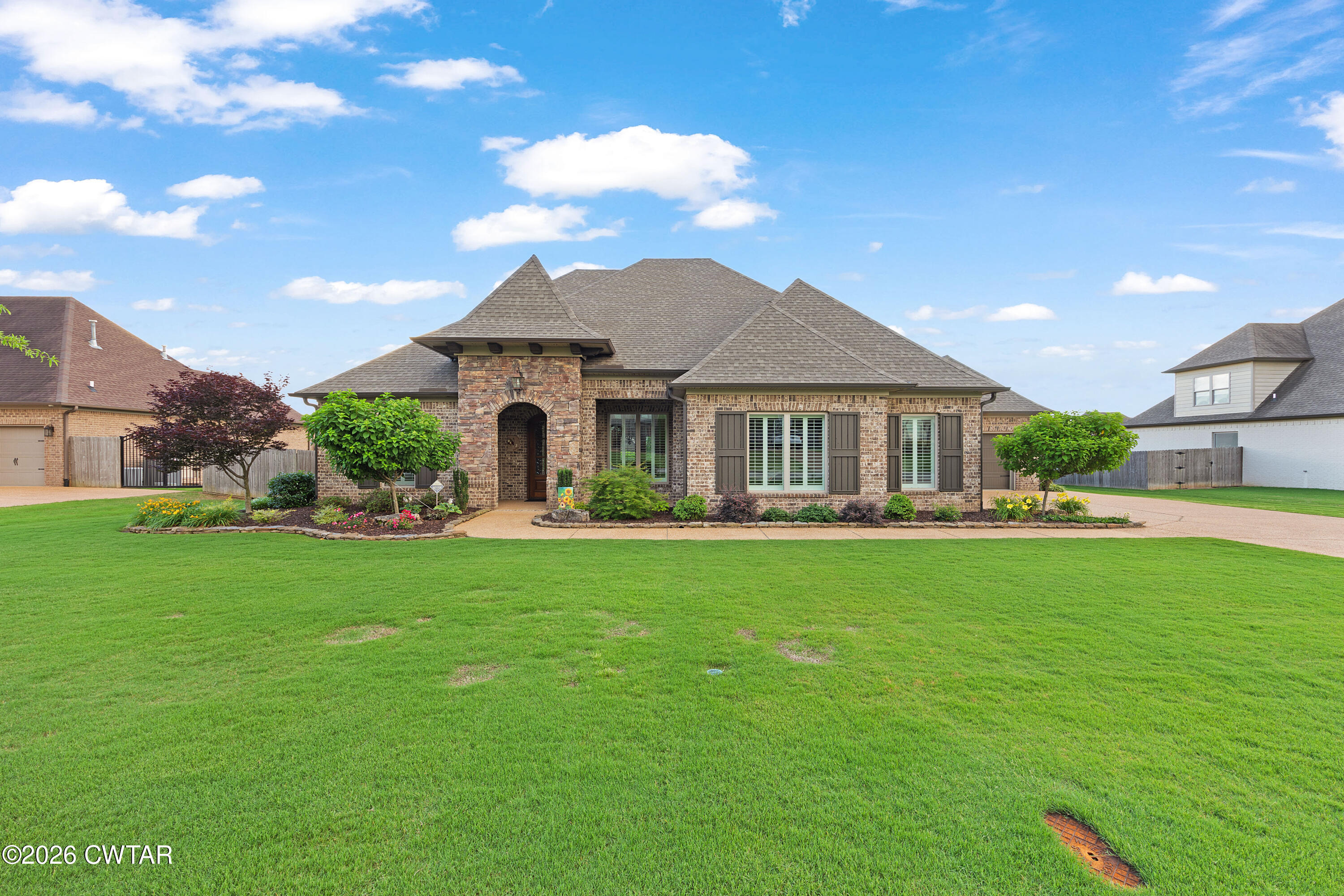 34 Cheddleton Cove Jackson, TN 38305 - Photo 1 of 32 a front view of a house with garden