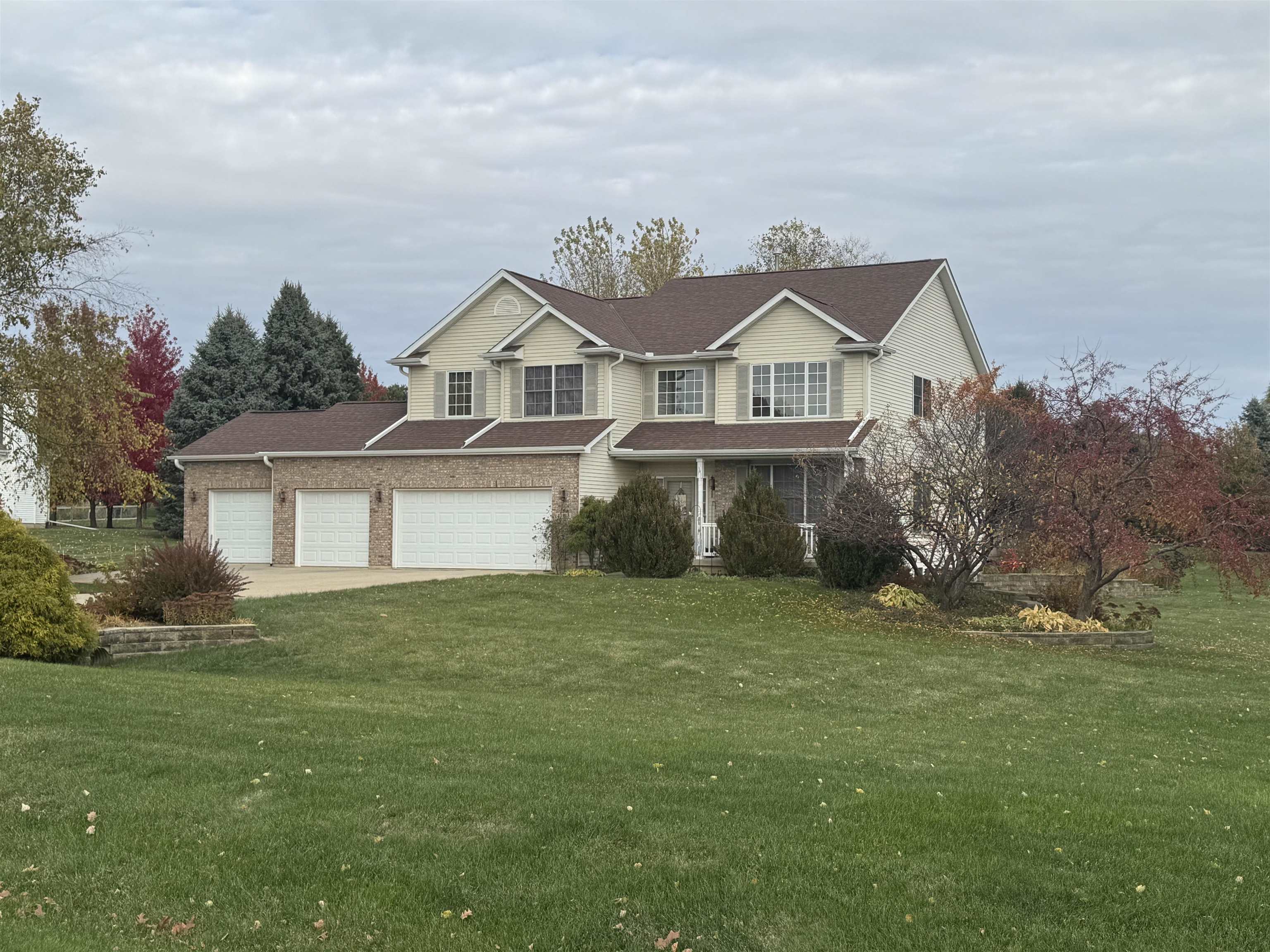 10133 Springborough Drive Rockford, IL 61107 - Photo 2 of 4 a front view of a house with a garden