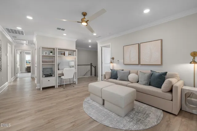 a living room with furniture and wooden floor