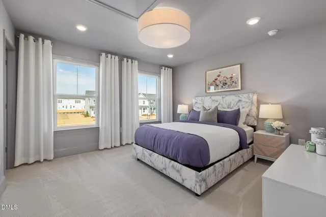 a spacious bedroom with a bed and a large window