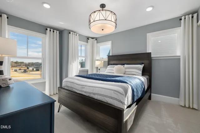 a bedroom with a bed a mirror and a window