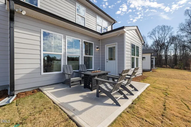 a view of a house with backyard porch and sitting area