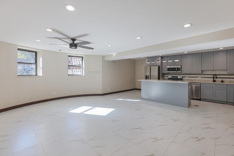 442 East 48th Street, Unit B1 Chicago, IL 60615 - Photo 11 of 21 a view of kitchen with stainless steel appliances granite countertop a stove top oven a sink dishwasher and a refrigerator with wooden floor