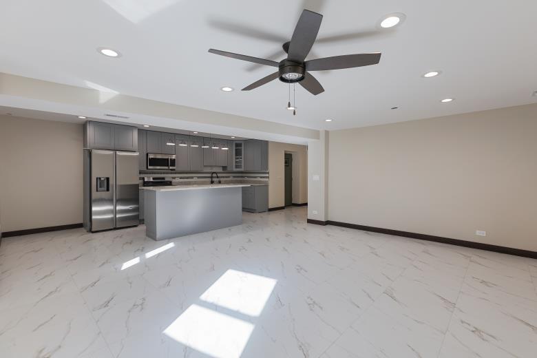 442 East 48th Street, Unit B1 Chicago, IL 60615 - Photo 12 of 21 a view of a kitchen with a microwave and a stove top oven