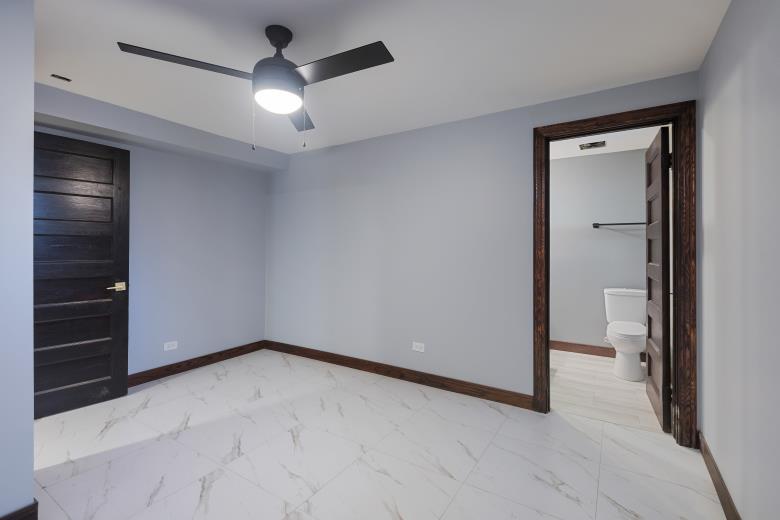 442 East 48th Street, Unit B1 Chicago, IL 60615 - Photo 15 of 21 wooden floor in an empty room and a bathroom