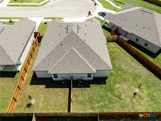 a aerial view of a house with a yard