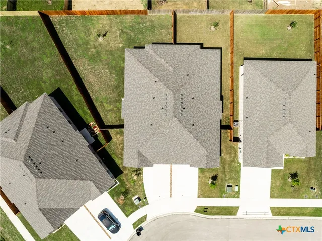 an aerial view of a house with a yard