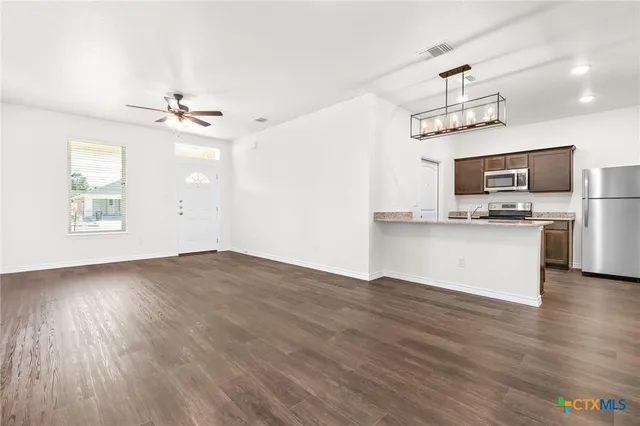 a view of kitchen with sink microwave and stove