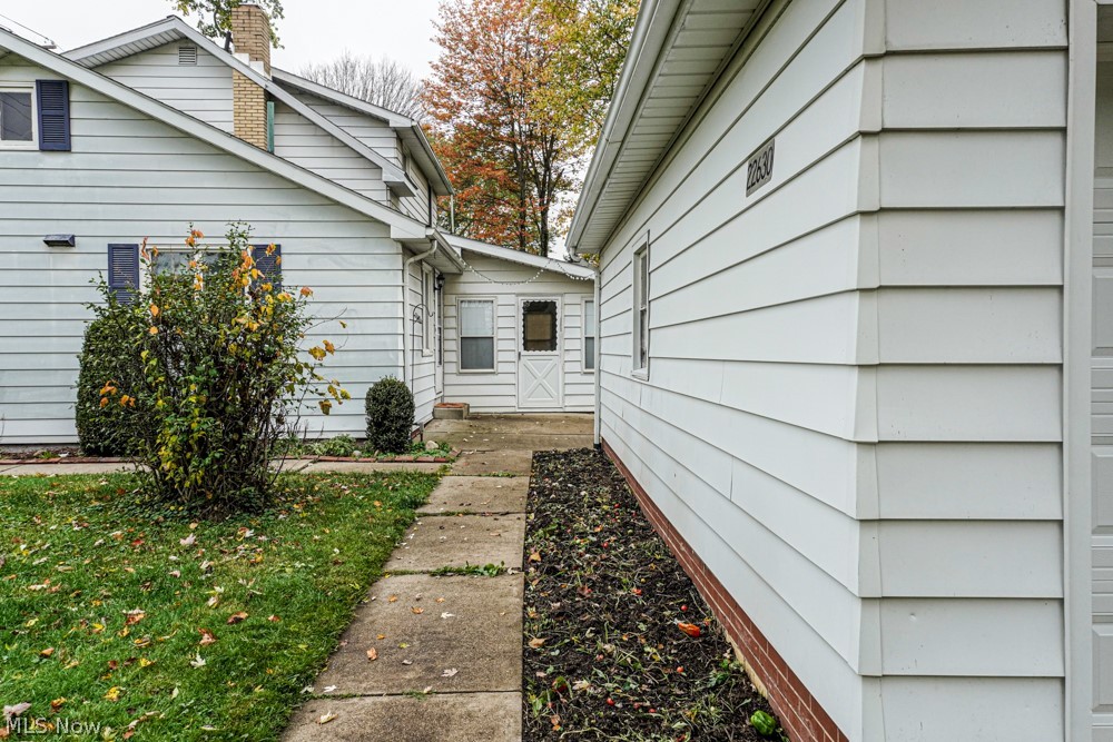 22630 Georgetown Road Homeworth, OH 44634 - Photo 29 of 35 Sidewalk from garage to house and sunroom on the back of the home