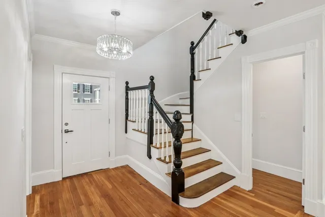 a view of entryway and hall with wooden floor