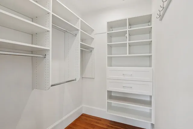 a view of walk in closet with empty racks