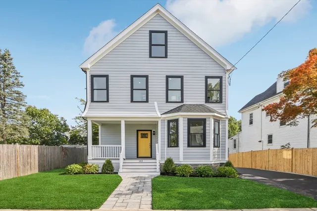 a front view of a house with garden and porch