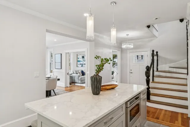 a kitchen with a sink a counter space and wooden floor