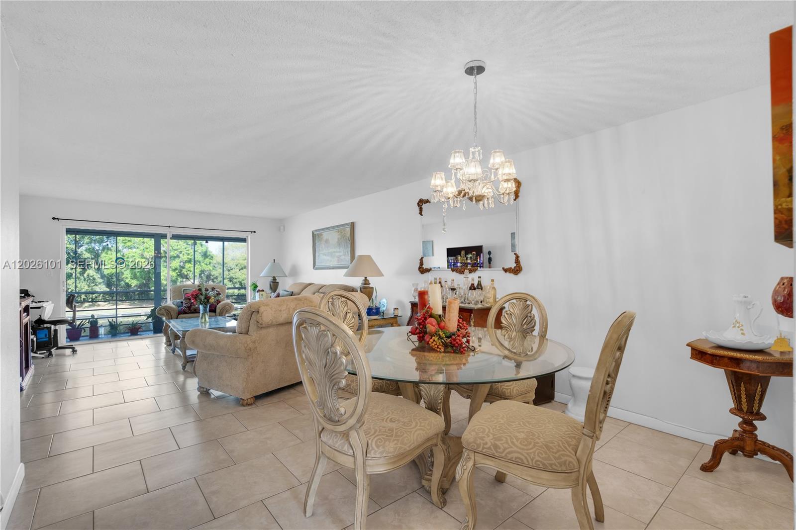 3551 Inverrary Drive, Unit 208 Lauderhill, FL 33319 - Photo 1 of 34 a dining room with furniture a chandelier and a rug