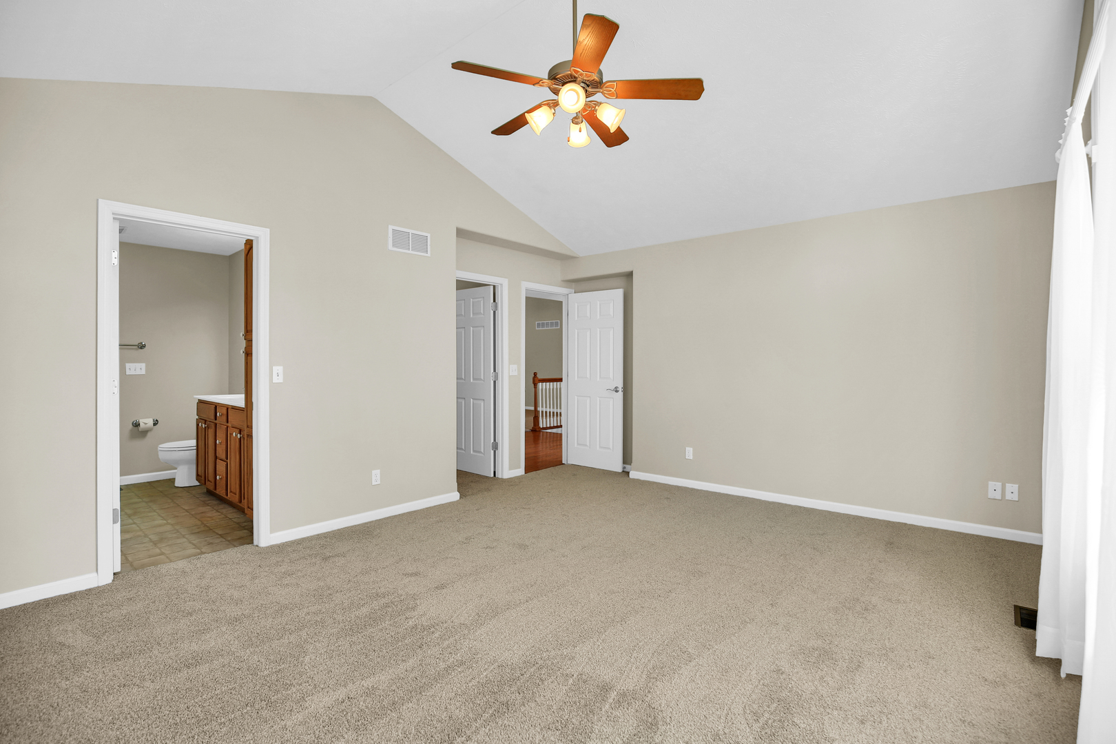 2004 Emerald Drive Champaign, IL 61822 - Photo 16 of 30 a view of a room with a ceiling fan and carpet