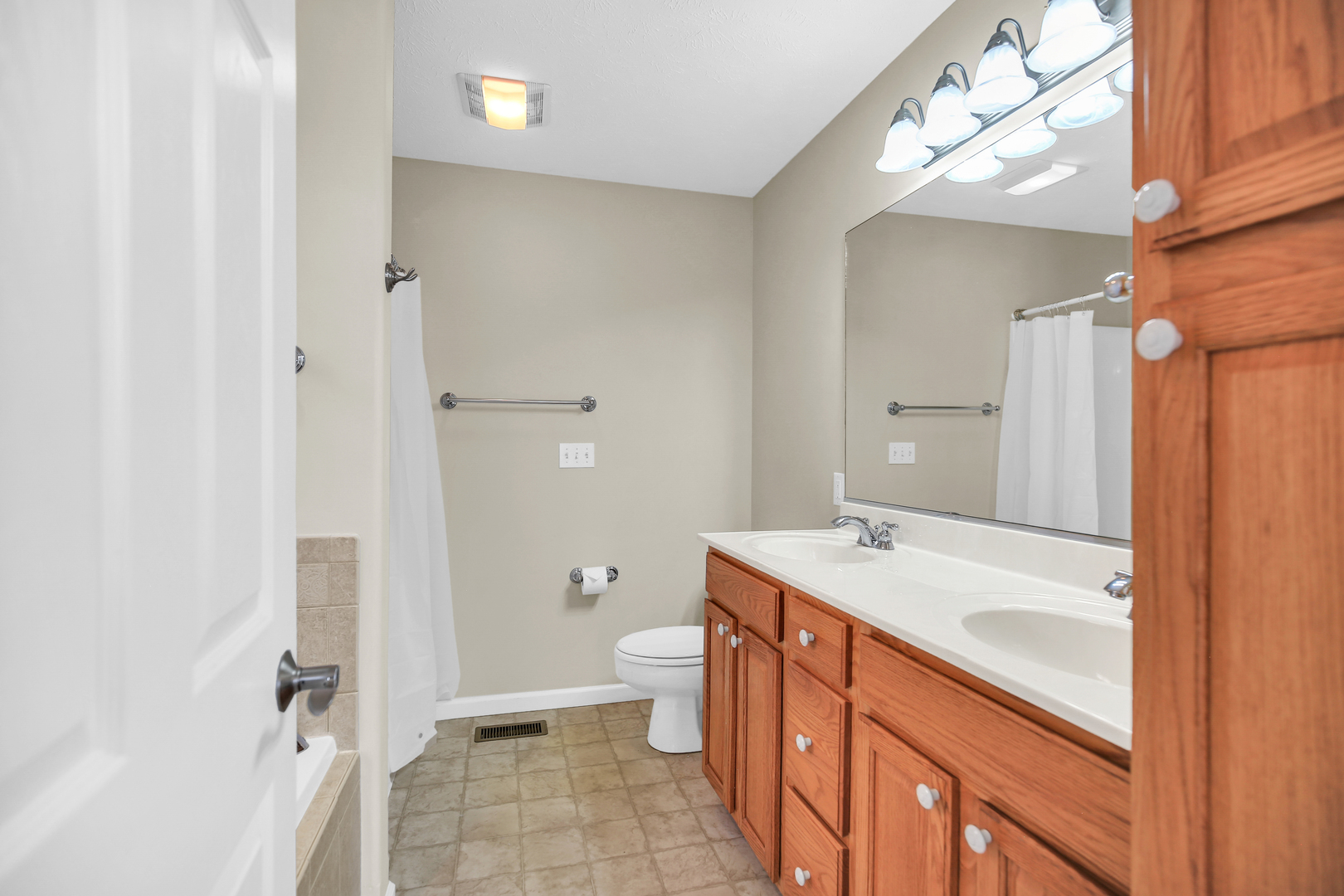 2004 Emerald Drive Champaign, IL 61822 - Photo 17 of 30 a bathroom with a sink a toilet a mirror and shower