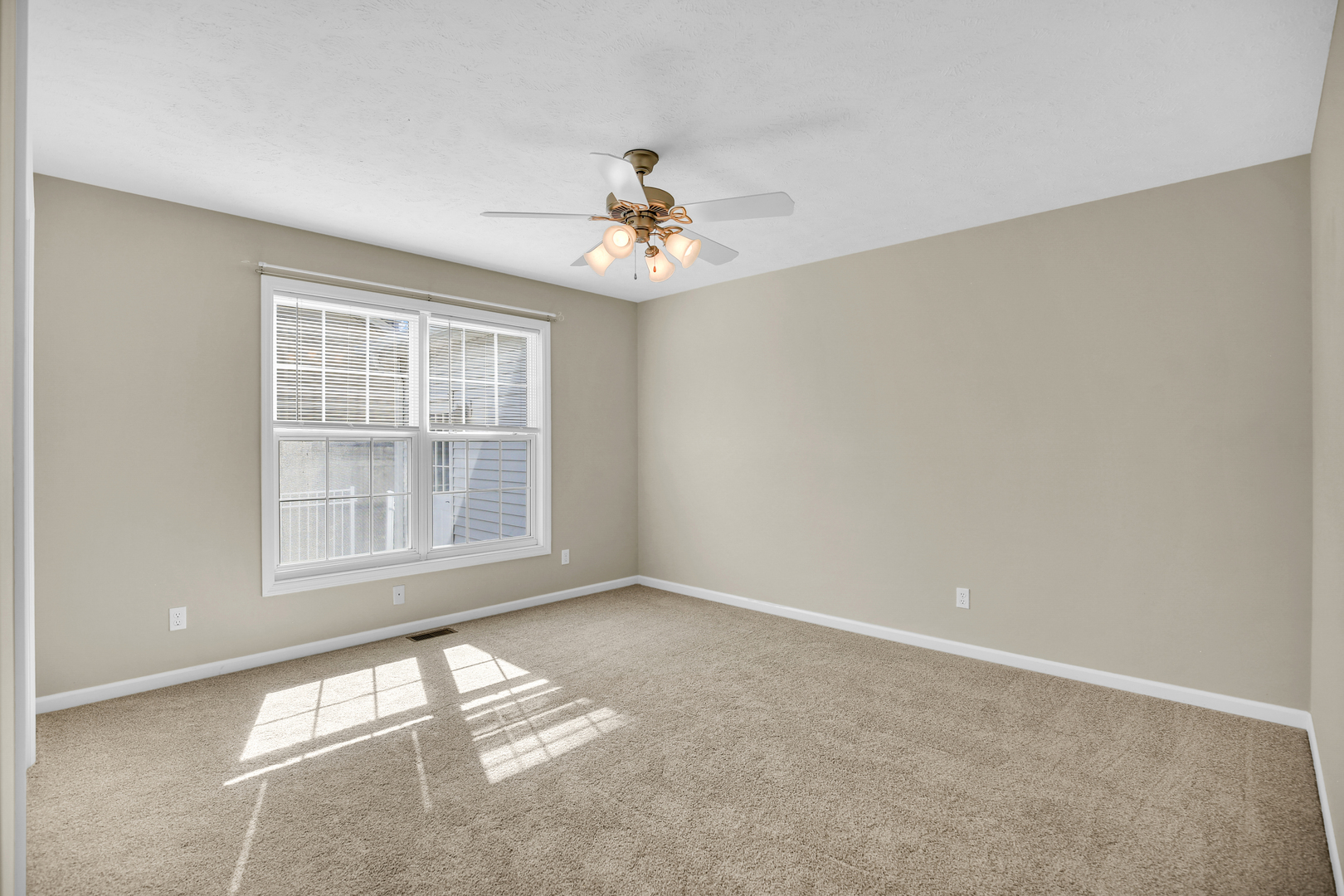 2004 Emerald Drive Champaign, IL 61822 - Photo 19 of 30 an empty room with windows and fan