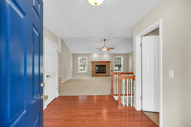 a view of a livingroom with wooden floor and stairs
