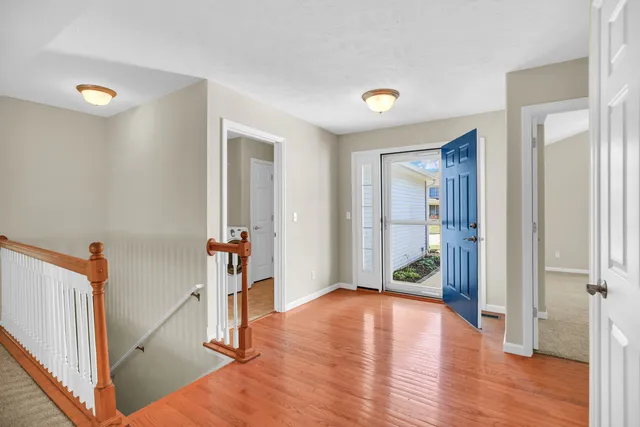 a view of an empty room with window and fireplace