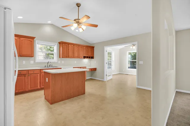 a large kitchen with stainless steel appliances granite countertop a stove sink and cabinets