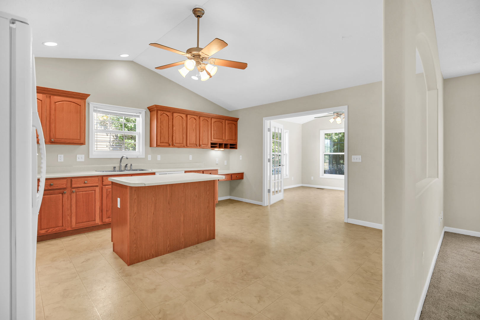 2004 Emerald Drive Champaign, IL 61822 - Photo 10 of 30 a large kitchen with a large counter top a sink stainless steel appliances and cabinets