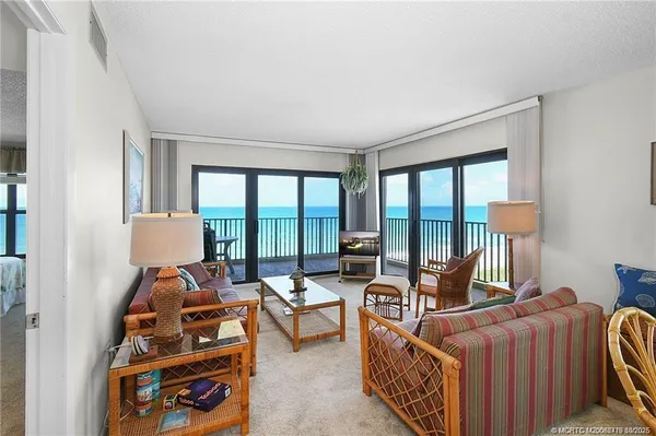 a bedroom with furniture and a large window