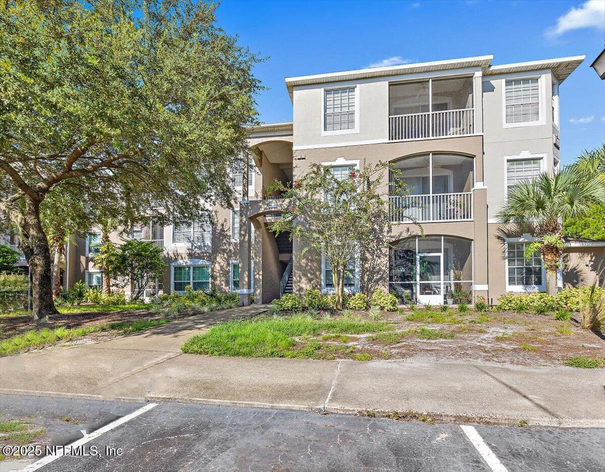10550 Baymeadows Road, Unit 807 Jacksonville, FL 32256 - Photo 20 of 22 a front view of a building with a garden and plants