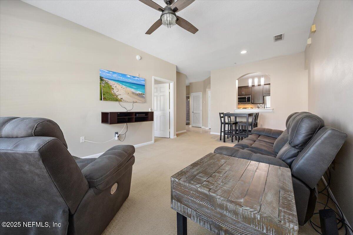 10550 Baymeadows Road, Unit 807 Jacksonville, FL 32256 - Photo 6 of 22 a living room with furniture and a flat screen tv